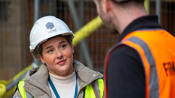Woman engineer talking to site worker
